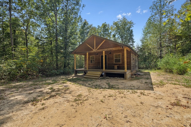 back of house featuring a porch