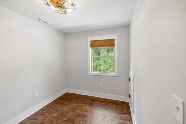 empty room with dark hardwood / wood-style flooring