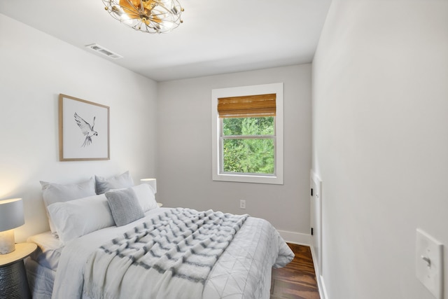 bedroom with dark hardwood / wood-style flooring