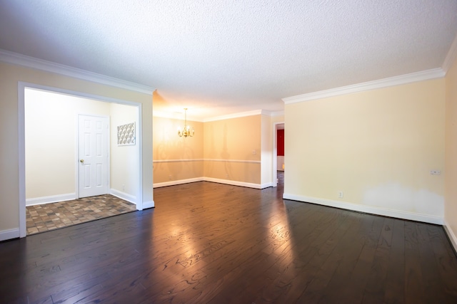 spare room with an inviting chandelier, dark hardwood / wood-style floors, ornamental molding, and a textured ceiling