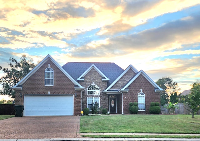 view of front of property featuring a lawn and a garage