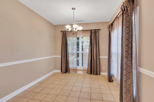 interior space with light tile patterned flooring and a chandelier