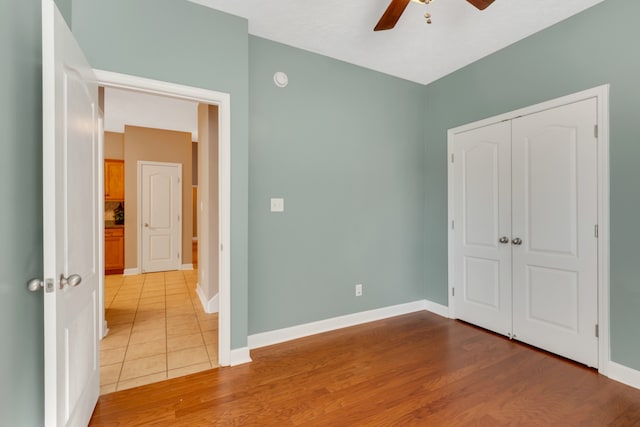 unfurnished bedroom featuring a closet, ceiling fan, and hardwood / wood-style floors