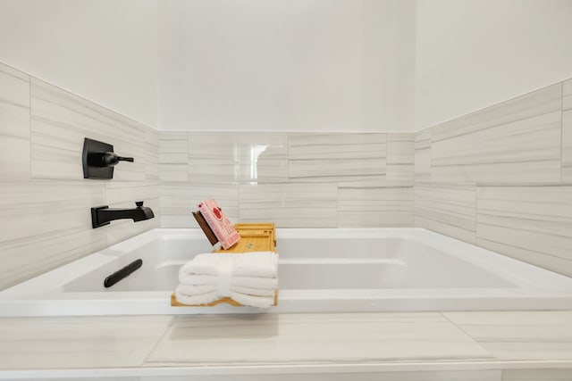 bathroom featuring tiled tub