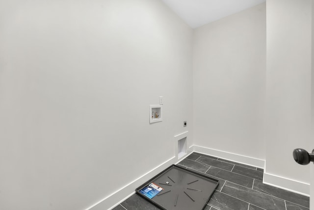 clothes washing area with hookup for a washing machine, hookup for an electric dryer, and dark tile patterned flooring