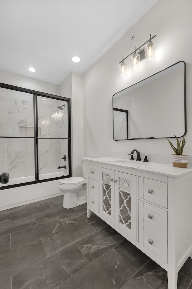 full bathroom with shower / bath combination with glass door, toilet, and vanity