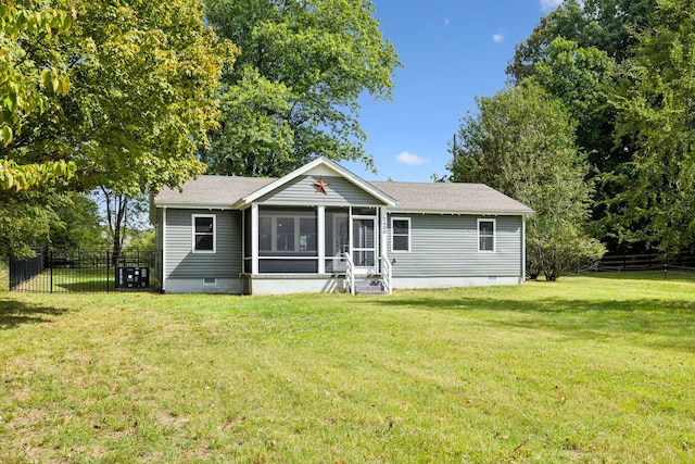 back of house featuring a sunroom and a yard