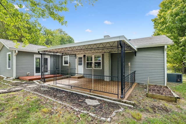 back of house with cooling unit and a deck