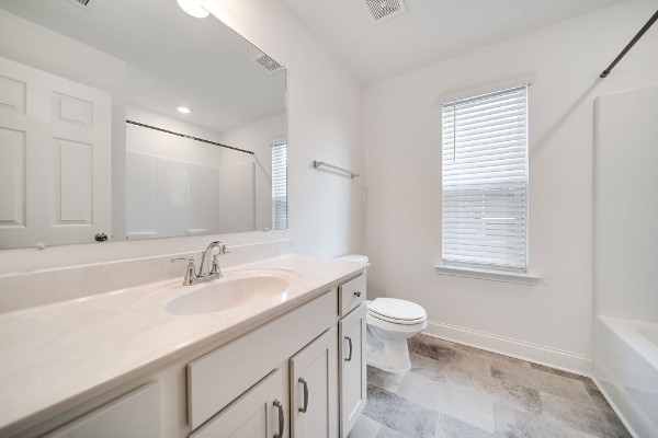 full bathroom with vanity, toilet, and  shower combination