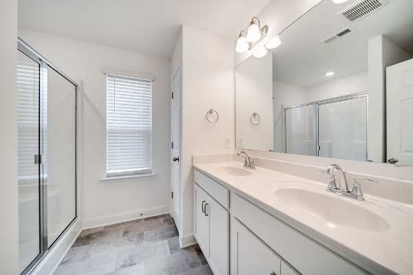 bathroom featuring vanity and a shower with shower door