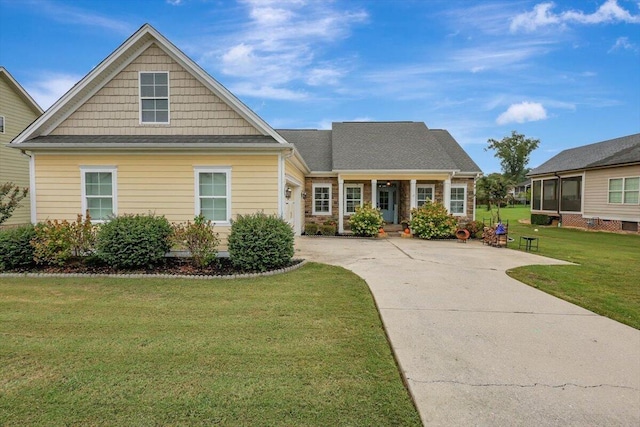 view of front of property featuring an attached garage, a front lawn, and concrete driveway
