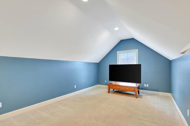 interior space featuring vaulted ceiling and light colored carpet