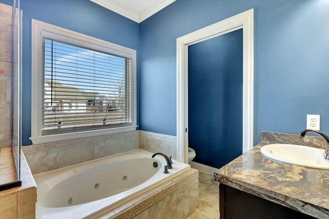 full bathroom featuring toilet, a sink, a jetted tub, and crown molding