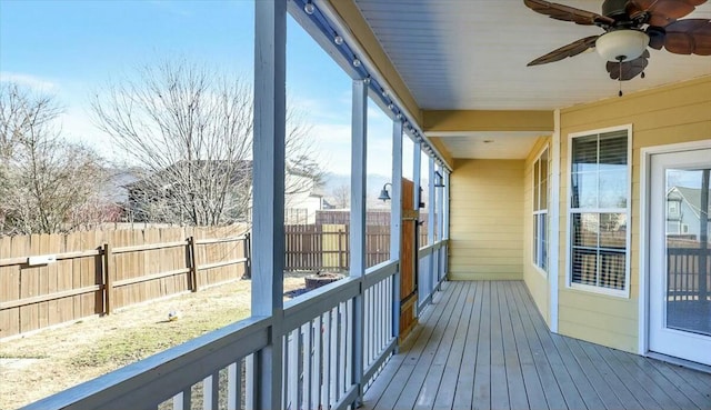 wooden deck with fence and a ceiling fan