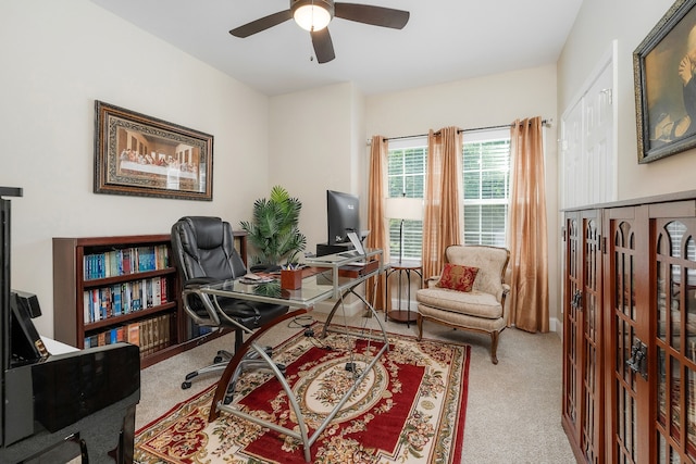 carpeted office space with ceiling fan