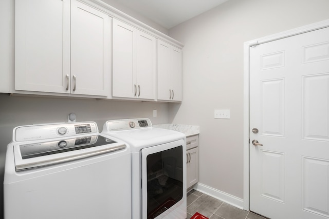 laundry room with cabinets, tile patterned flooring, and washer and dryer