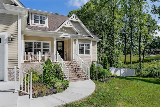 view of front of house featuring a porch and a front lawn