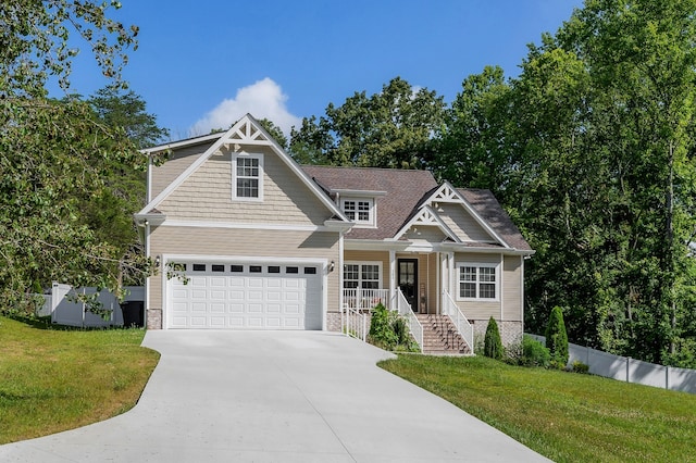 craftsman inspired home with a front yard, a porch, and a garage