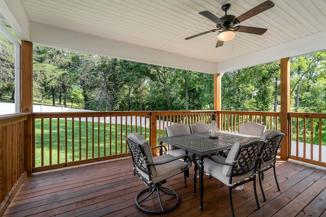 deck with a lawn and ceiling fan