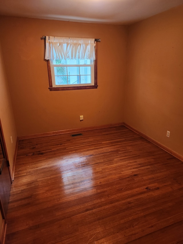 spare room with dark wood-type flooring