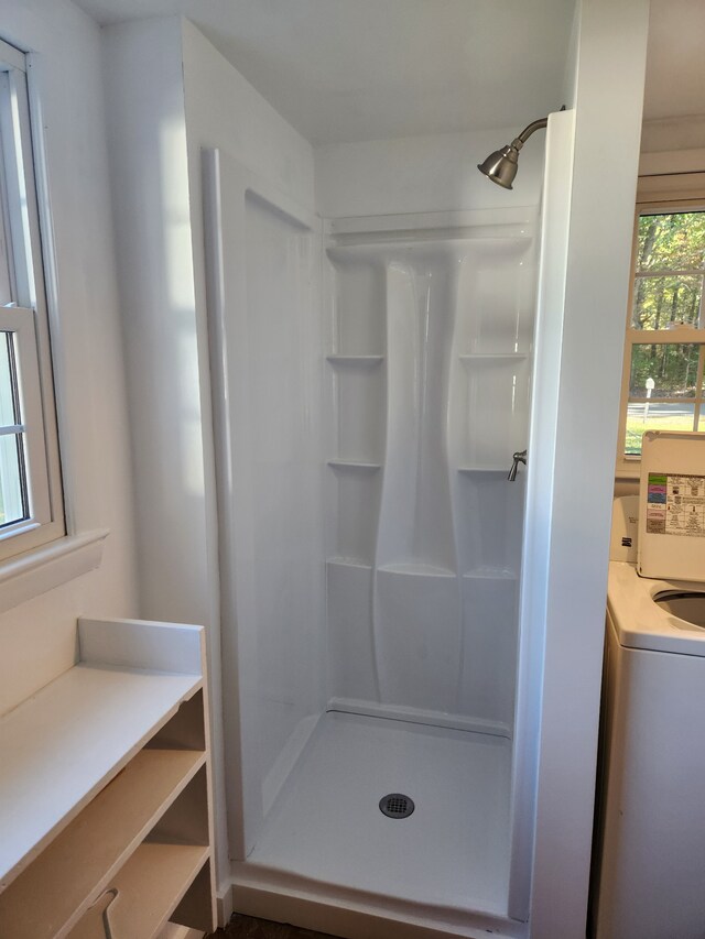 bathroom featuring a shower and washer / dryer