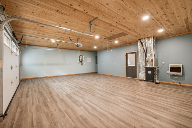 interior space featuring wood ceiling, heating unit, and light hardwood / wood-style flooring