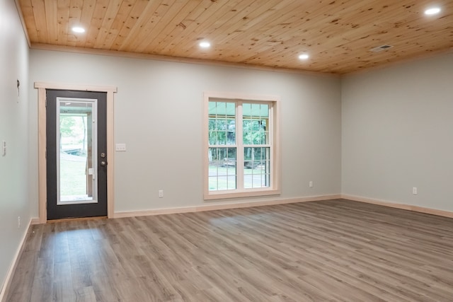 foyer entrance with light wood-type flooring, crown molding, and wood ceiling