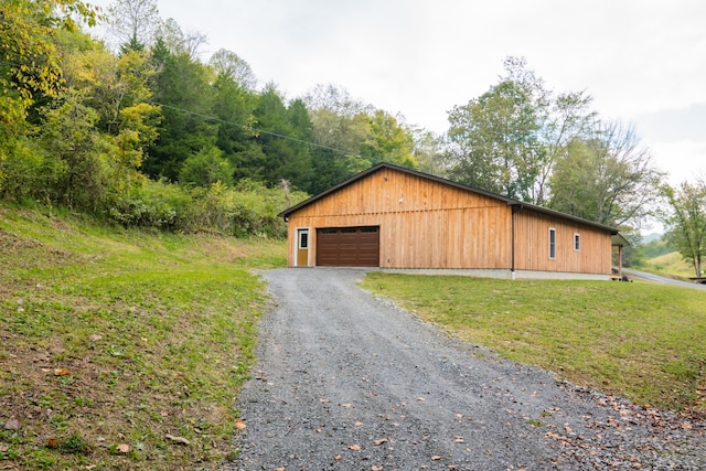 exterior space featuring a lawn and a garage