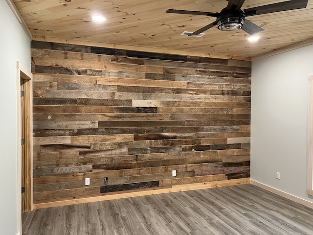 unfurnished room featuring wooden ceiling, wood walls, ceiling fan, and hardwood / wood-style flooring