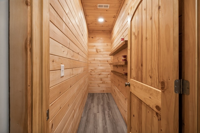 room details featuring wood-type flooring, wooden walls, and wooden ceiling