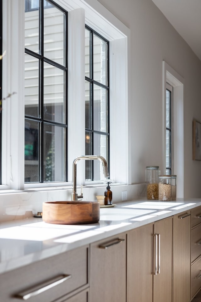 bar featuring light brown cabinetry