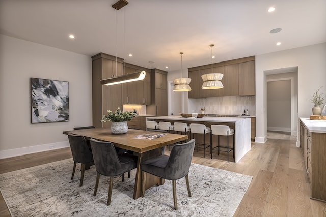 dining space with light hardwood / wood-style flooring