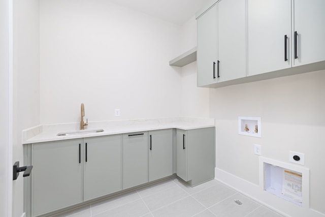 laundry room featuring sink, washer hookup, cabinets, hookup for an electric dryer, and light tile patterned flooring