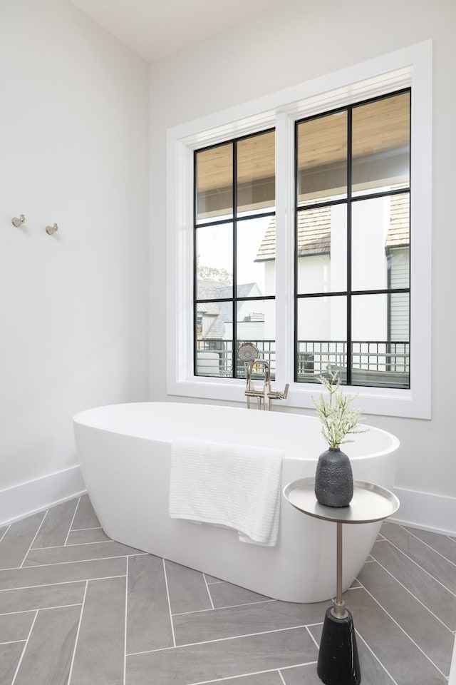 bathroom with tile patterned floors and a bathing tub