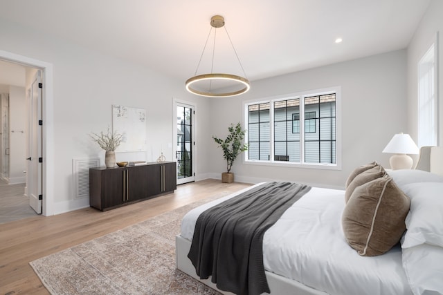 bedroom featuring multiple windows and light wood-type flooring