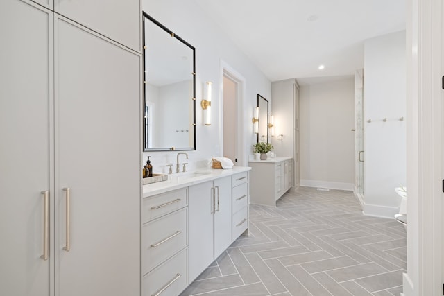 bathroom featuring vanity and a shower with shower door