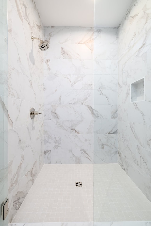 bathroom with tiled shower