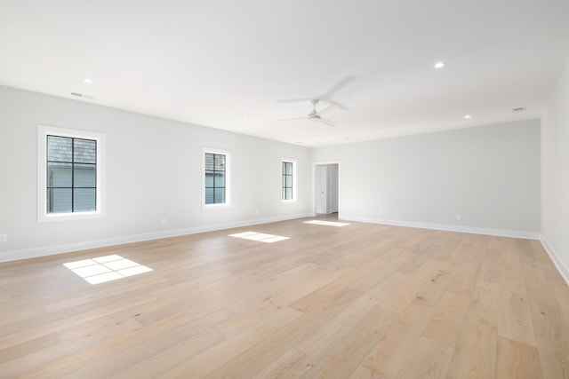 spare room featuring light hardwood / wood-style flooring and ceiling fan