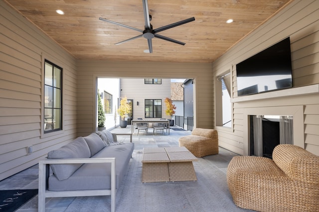 interior space with an outdoor living space and ceiling fan