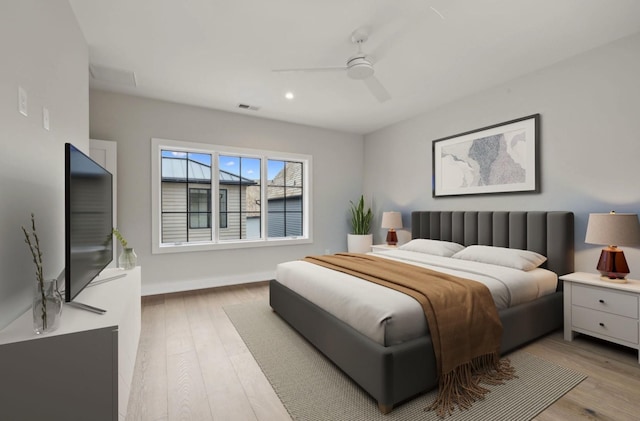 bedroom with ceiling fan and light hardwood / wood-style flooring