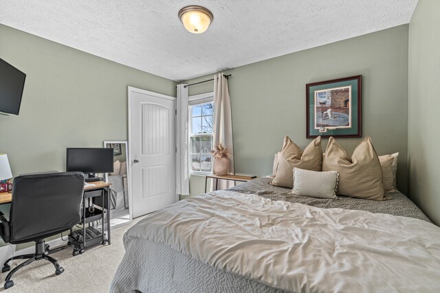 carpeted bedroom featuring a textured ceiling