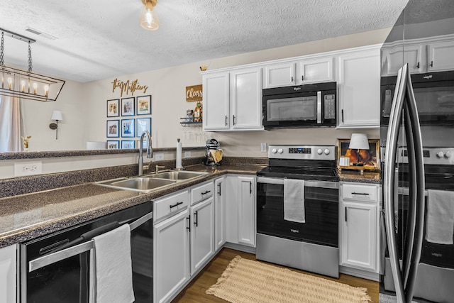 kitchen with light hardwood / wood-style floors, wine cooler, white cabinets, stainless steel appliances, and sink