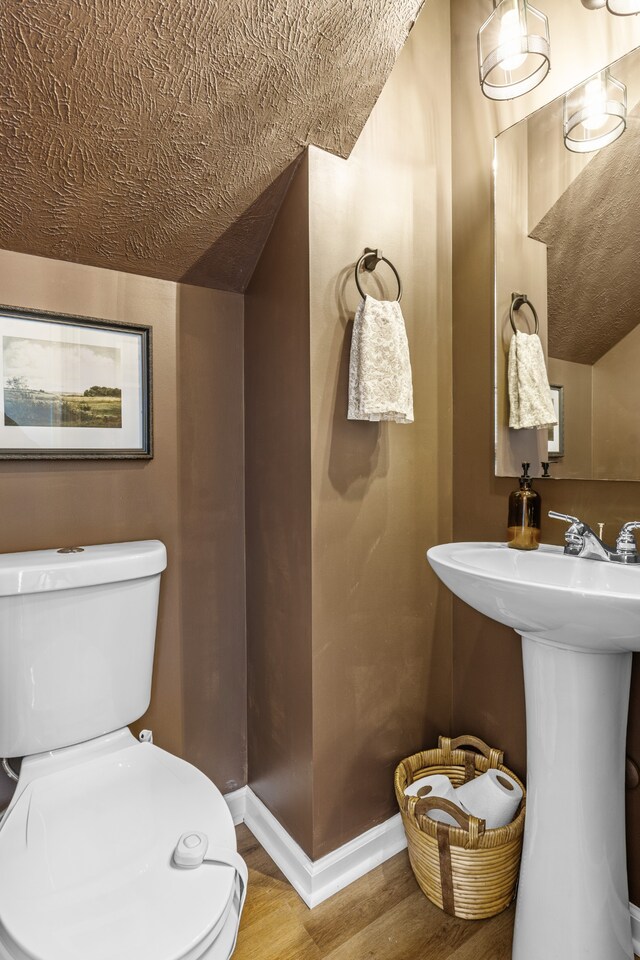 bathroom featuring hardwood / wood-style floors and toilet