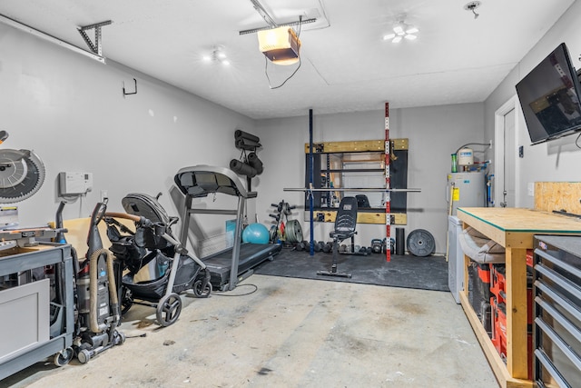 garage with a garage door opener, a workshop area, and water heater