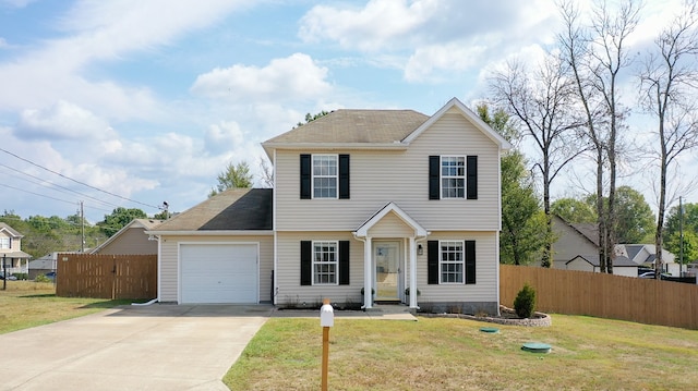 view of front of home with a front lawn and a garage