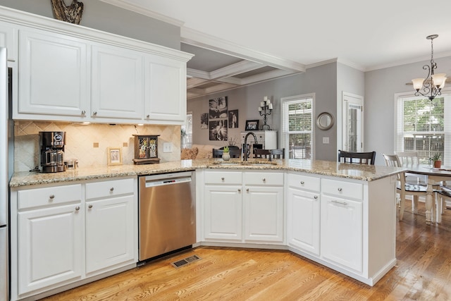 kitchen with dishwasher, sink, a notable chandelier, and white cabinetry