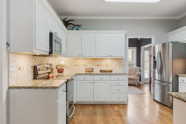 kitchen featuring ornamental molding, light hardwood / wood-style flooring, backsplash, white cabinetry, and appliances with stainless steel finishes