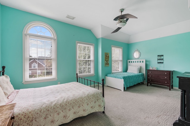 bedroom featuring ceiling fan, vaulted ceiling, and carpet flooring