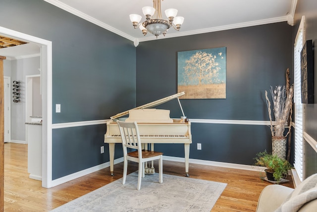 miscellaneous room featuring ornamental molding, an inviting chandelier, and hardwood / wood-style floors