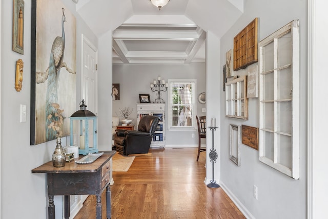 entryway with coffered ceiling, beamed ceiling, and hardwood / wood-style floors